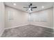 Expansive bedroom boasts a ceiling fan, plush gray carpeting, and three sunlit windows with blinds at 4294 Eagle Summit Ave, Las Vegas, NV 89141