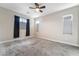 Spacious bedroom featuring carpet, large windows, and a modern ceiling fan at 4294 Eagle Summit Ave, Las Vegas, NV 89141