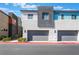 Modern townhome featuring two-car garage and neutral color palette, creating a clean and contemporary curb appeal at 4294 Eagle Summit Ave, Las Vegas, NV 89141