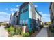 Modern townhome featuring vibrant blue siding and landscaped front yard at 4294 Eagle Summit Ave, Las Vegas, NV 89141