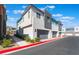 Corner view of a modern townhome showcases a two-car garage, landscaped frontage, and contemporary architectural style at 4294 Eagle Summit Ave, Las Vegas, NV 89141