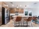Modern kitchen featuring an island with barstool seating, sleek brown cabinetry, and stainless steel appliances at 4294 Eagle Summit Ave, Las Vegas, NV 89141