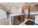 A modern kitchen with an island featuring a stainless steel dishwasher and sink, complemented by stainless steel appliances at 4294 Eagle Summit Ave, Las Vegas, NV 89141