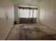 Bedroom with large window covered by curtains at 4338 Caliente St # 8, Las Vegas, NV 89119
