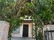 Charming front entrance with mature landscaping and a secure wrought iron security door at 4338 Caliente St # 8, Las Vegas, NV 89119