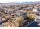 Aerial view of a home with desert landscaping, a tile roof, and a small green backyard at 436 Trevinca St, Las Vegas, NV 89138