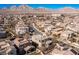This aerial shot shows a community of stucco homes with tile roofs and mountain views at 436 Trevinca St, Las Vegas, NV 89138
