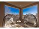 Cozy covered balcony with cushioned egg chairs and neighborhood views at 436 Trevinca St, Las Vegas, NV 89138