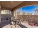 Inviting covered patio area with stone pavers and a comfortable seating arrangement at 436 Trevinca St, Las Vegas, NV 89138