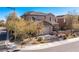 Corner lot featuring a two-story home with desert landscaping, a two-car garage and decorative stone facade at 436 Trevinca St, Las Vegas, NV 89138