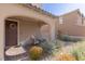 Charming front porch area featuring a comfortable rocking chair and decorative wreath on the front door at 436 Trevinca St, Las Vegas, NV 89138
