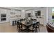 Open kitchen with stainless appliances, granite countertops, island and adjacent dining area at 436 Trevinca St, Las Vegas, NV 89138