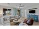 Comfortable living room featuring stylish furnishings, light blue curtains, and a ceiling fan at 436 Trevinca St, Las Vegas, NV 89138