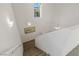 Open staircase leading to second floor, with wall sconces and natural light at 436 Trevinca St, Las Vegas, NV 89138