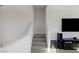 Carpeted staircase leading to the upper level, adjacent to a TV and entertainment unit at 436 Trevinca St, Las Vegas, NV 89138