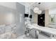 Modern bathroom featuring marble finishes, dual sinks, and glass-enclosed toilet area at 4381 W Flamingo Rd # 3206, Las Vegas, NV 89103