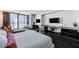 Well-lit bedroom featuring a built-in workstation, entertainment center, and balcony access at 4381 W Flamingo Rd # 3206, Las Vegas, NV 89103