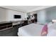 Bright bedroom featuring a workstation, dark wood floors, and integrated entertainment at 4381 W Flamingo Rd # 3206, Las Vegas, NV 89103