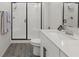Bathroom featuring sleek quartz counters, a modern walk-in shower with glass door, and plank flooring at 4526 Cloudrest Peak St, North Las Vegas, NV 89031