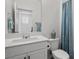Stylish bathroom with a modern vanity, white countertop, and a decorative shower curtain, creating a peaceful retreat at 4526 Cloudrest Peak St, North Las Vegas, NV 89031