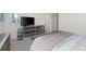 Bedroom with mirrored dresser, large TV and neutral-toned bedding, and dual closet doors at 4526 Cloudrest Peak St, North Las Vegas, NV 89031