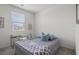 Cozy bedroom features a plush bed, modern desk, and ample natural light, offering a comfortable and functional space at 4526 Cloudrest Peak St, North Las Vegas, NV 89031