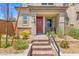 Home exterior with brick pathway leading to red front door and a covered entryway at 4526 Cloudrest Peak St, North Las Vegas, NV 89031
