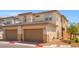 Modern townhome featuring well-maintained landscaping, a private two-car garage, and convenient access, enhancing curb appeal and functionality at 4526 Cloudrest Peak St, North Las Vegas, NV 89031