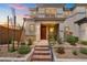 Inviting two-story home with red brick steps and beautifully landscaped front yard at 4526 Cloudrest Peak St, North Las Vegas, NV 89031