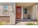 Charming front entry featuring a brick walkway, a red front door, and covered porch at 4526 Cloudrest Peak St, North Las Vegas, NV 89031