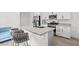 The kitchen features an island with bar stool seating, stainless steel appliances, and granite countertops at 4526 Cloudrest Peak St, North Las Vegas, NV 89031
