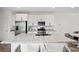 Bright kitchen featuring granite countertops, stainless steel appliances, bar seating, and wood-look flooring at 4526 Cloudrest Peak St, North Las Vegas, NV 89031
