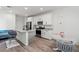 Modern kitchen showcases white cabinets, stainless appliances, granite counters, island with bar stools and adjacent table at 4526 Cloudrest Peak St, North Las Vegas, NV 89031