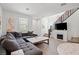 Comfortable living room with wood floors, neutral paint, fireplace, and a cozy sectional sofa at 4526 Cloudrest Peak St, North Las Vegas, NV 89031