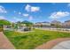 Community playground with a covered picnic area and lush green space, providing a recreational space for residents and families at 4526 Cloudrest Peak St, North Las Vegas, NV 89031