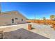 Spacious backyard featuring gravel landscaping, wood fence, picnic table, and fire pit area at 474 Adelle Ave, Overton, NV 89040