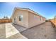 Side view of backyard featuring concrete and gravel areas along the house at 474 Adelle Ave, Overton, NV 89040