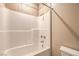 Clean bathroom featuring a shower-tub combo with white tiled walls and a shower head at 474 Adelle Ave, Overton, NV 89040