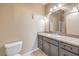 Modern bathroom featuring a toilet, sink, vanity with granite countertops and decorative mirror at 474 Adelle Ave, Overton, NV 89040