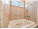 Bathroom showcasing soaking tub, window, and tile accents at 474 Adelle Ave, Overton, NV 89040