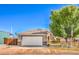 Charming single-story home featuring a two-car garage, neat landscaping and a quaint wooden fence at 474 Adelle Ave, Overton, NV 89040
