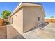 Exterior corner view of the house showcasing the cement walkway and partial backyard at 474 Adelle Ave, Overton, NV 89040
