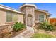 Inviting front entrance with stone accents, manicured shrubs, and a charming walkway at 474 Adelle Ave, Overton, NV 89040