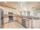 Open kitchen with stainless steel appliances, granite counters, and views to living area at 474 Adelle Ave, Overton, NV 89040