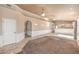 Open-concept living room with neutral walls, carpet, ceiling fans, and a glimpse into the kitchen at 474 Adelle Ave, Overton, NV 89040