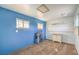 Carpeted room featuring blue walls, two windows, peg board on the wall, and a drop ceiling at 474 Adelle Ave, Overton, NV 89040