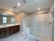 Bright bathroom with a glass-enclosed shower, double vanity, and modern fixtures at 483 Fairview Hills St, Las Vegas, NV 89138