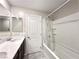 Well-lit bathroom featuring a double vanity with modern fixtures and a shower-tub combination at 483 Fairview Hills St, Las Vegas, NV 89138