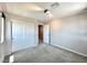 Bright bedroom with neutral walls and carpet, sliding-door closet, and hallway view at 483 Fairview Hills St, Las Vegas, NV 89138