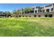 Well-manicured community lawn with rows of modern townhomes in the background on a clear day at 483 Fairview Hills St, Las Vegas, NV 89138